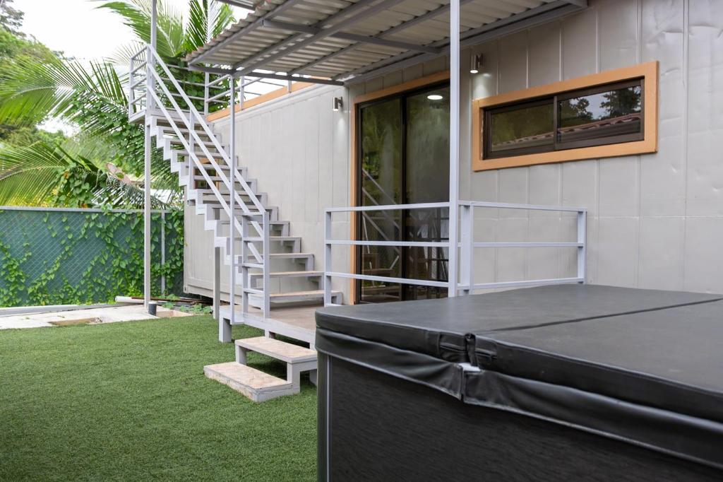 a house with a table and a stair case at Good Vibes Apartments in Talamanca