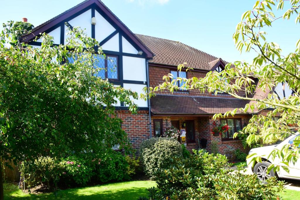 a red brick house with a large window at Beechwood B and B in Halland