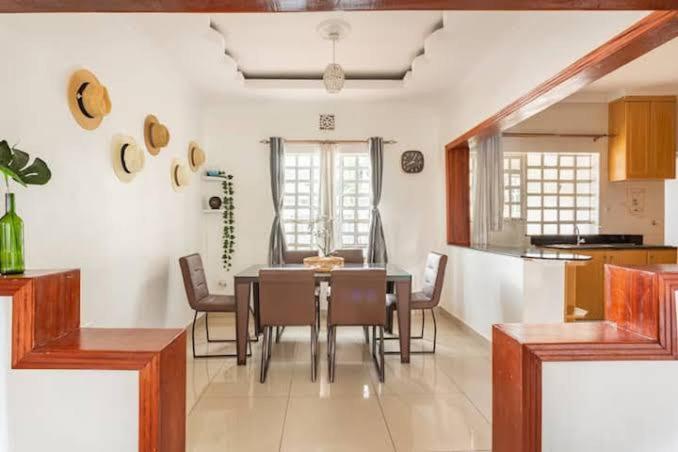 a kitchen and dining room with a table and chairs at Js apartments in Narok