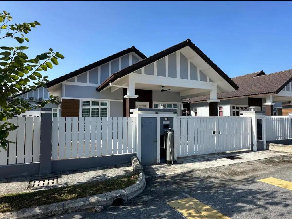 a white fence in front of a house at Live Well Homestay Senawang in Seremban