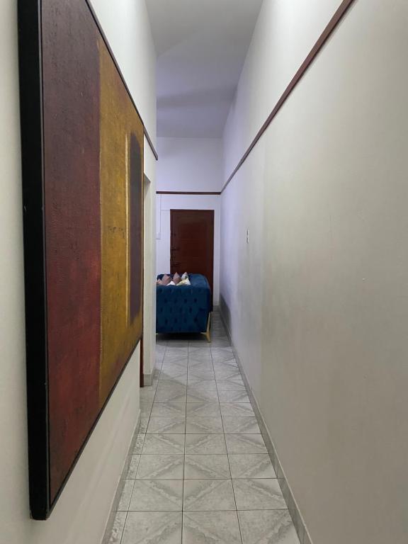 a hallway with a blue couch in a room at MozBnb in Maputo