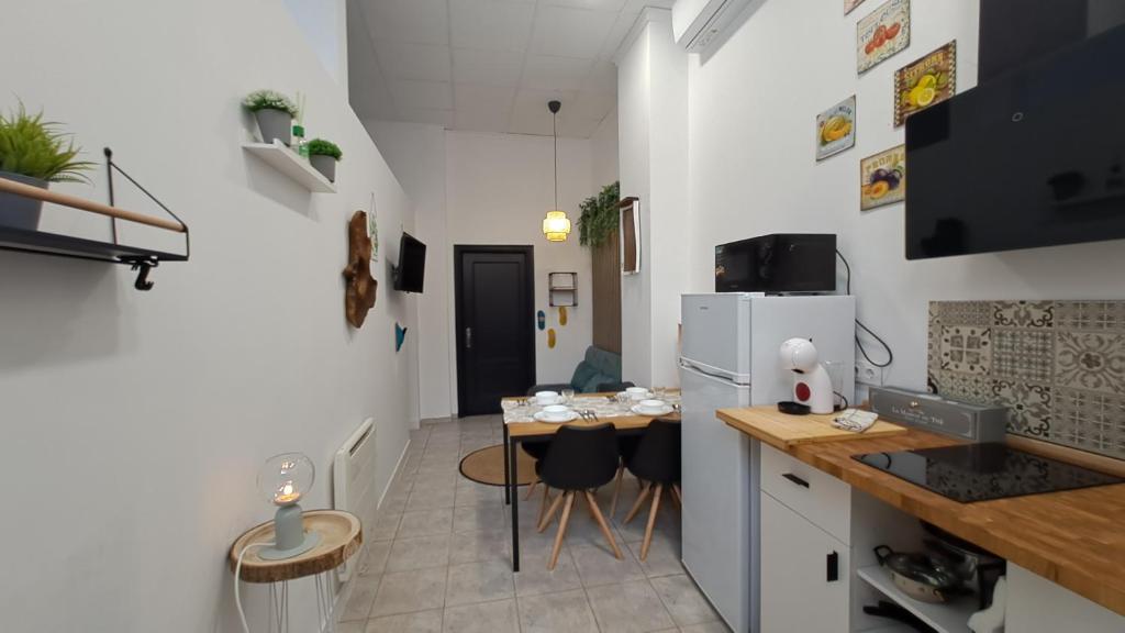 una pequeña cocina con mesa y nevera en URBAN LOFT VALENCIA, en Valencia