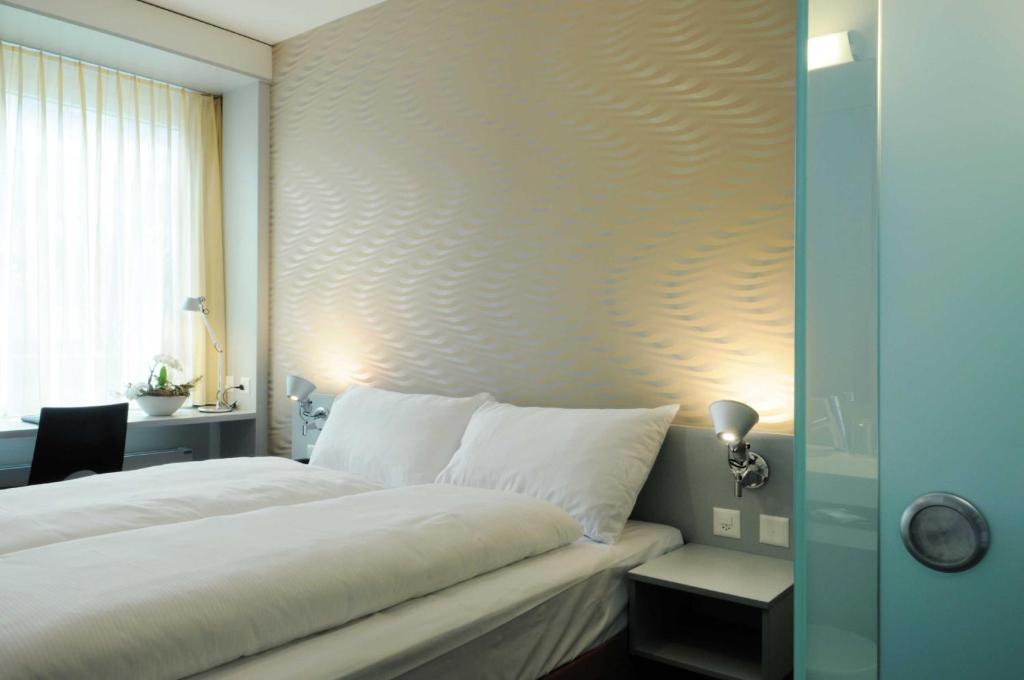 Postel nebo postele na pokoji v ubytování Sorell Hotel Ador