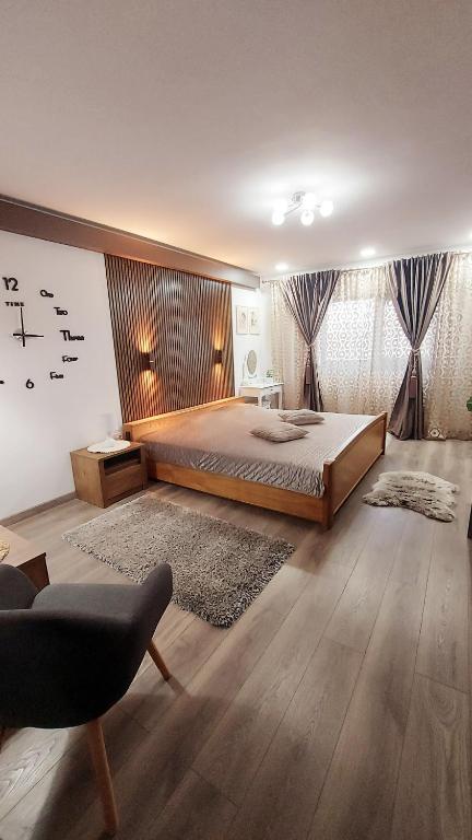 a bedroom with a bed and a clock on the wall at Cuza 21 in Brăila