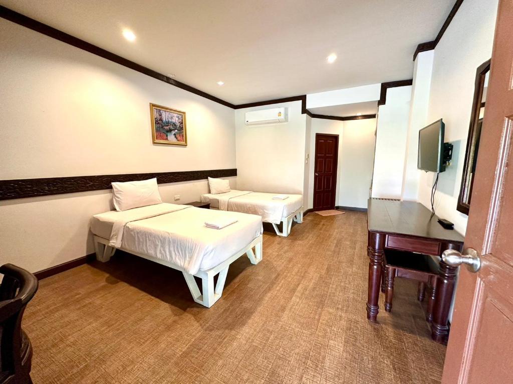 Postel nebo postele na pokoji v ubytování บ้านสวนรีสอร์ท นครสวรรค์