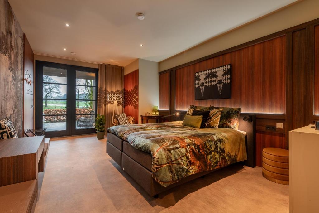 sypialnia z dużym łóżkiem i stołem w obiekcie Tumuli Twente B&B Boutique Hotel w mieście Nutter