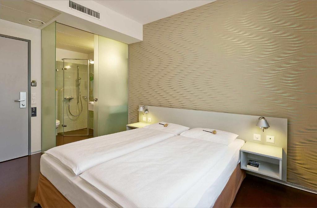 Postel nebo postele na pokoji v ubytování Sorell Hotel Ador