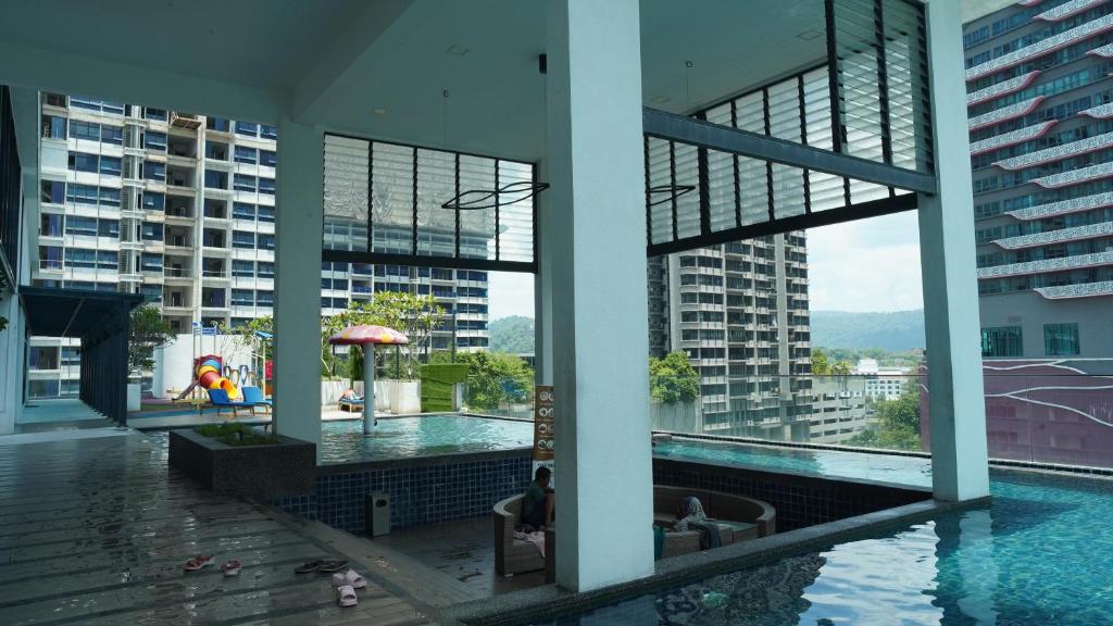 a swimming pool in a building with buildings at Reizz Residence by Elysium in Kuala Lumpur