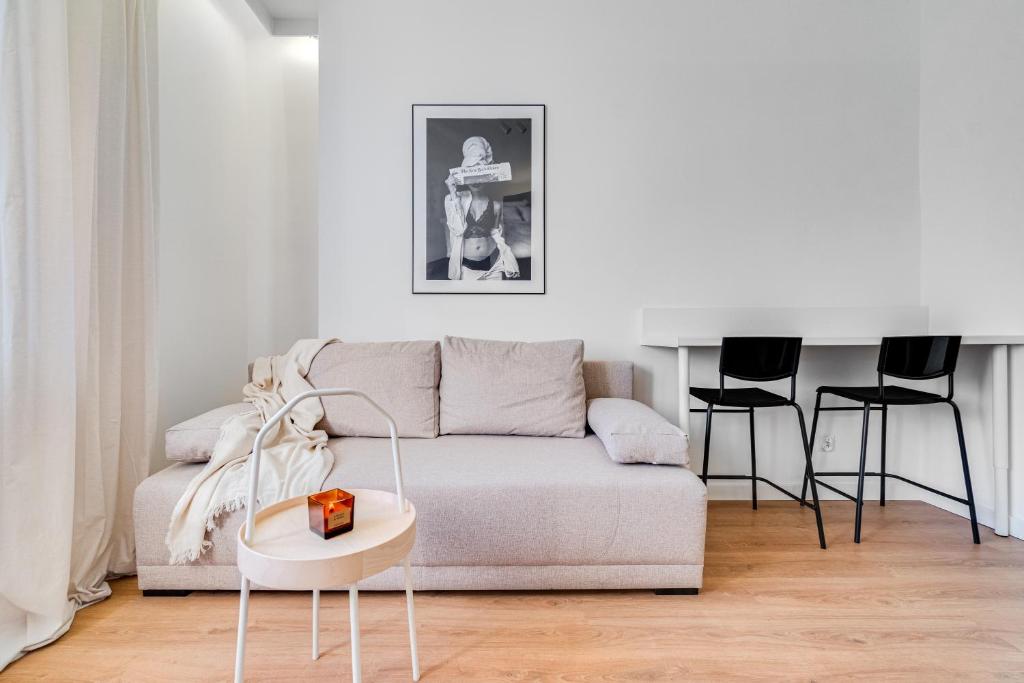 a living room with a couch and a table at Hann Haven Apartments Armii krajowej 16 in Opole