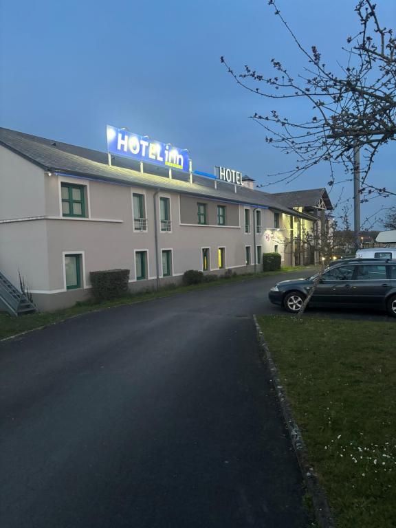 a hotel with a car parked in front of it at Hotel Inn Design Laon in Laon