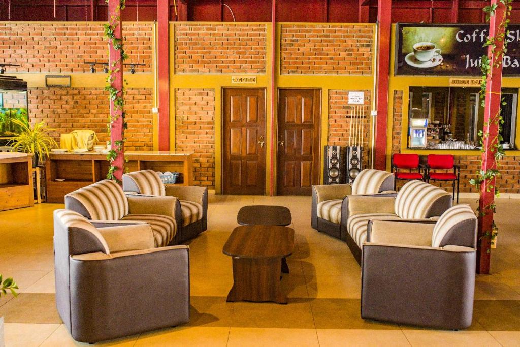 a lobby with couches and a table in a building at New saniro Lagoon Deck in Katunayake
