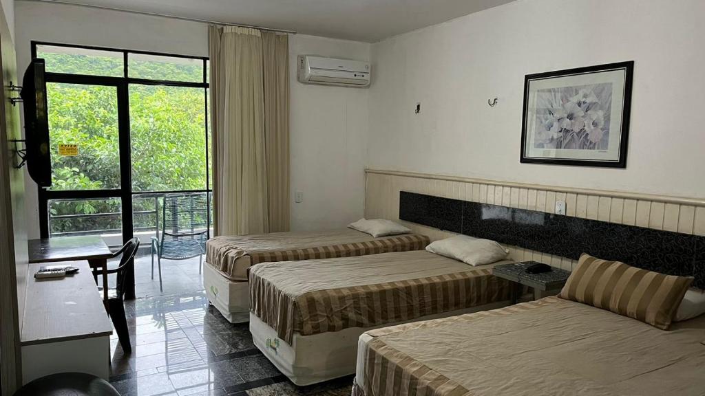 Postelja oz. postelje v sobi nastanitve Ytacaranha Hotel de Serra