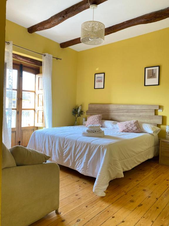 a bedroom with a large bed and a couch at Hotel Restaurante Agapio de TRESNIÑO in Quintanilla de Onésimo