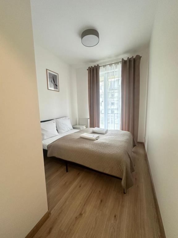 a bedroom with a bed and a window at Apartament ŻELAZNY HGS Home in Gorzów Wielkopolski