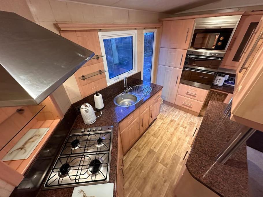 an overhead view of a kitchen with a stove and a sink at Atlas 2 Bedroom Caravan, Glasgow in Uddingston
