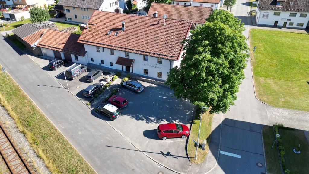 an overhead view of a house with cars parked in a parking lot at Gasthaus zum Stausee in Grafenau