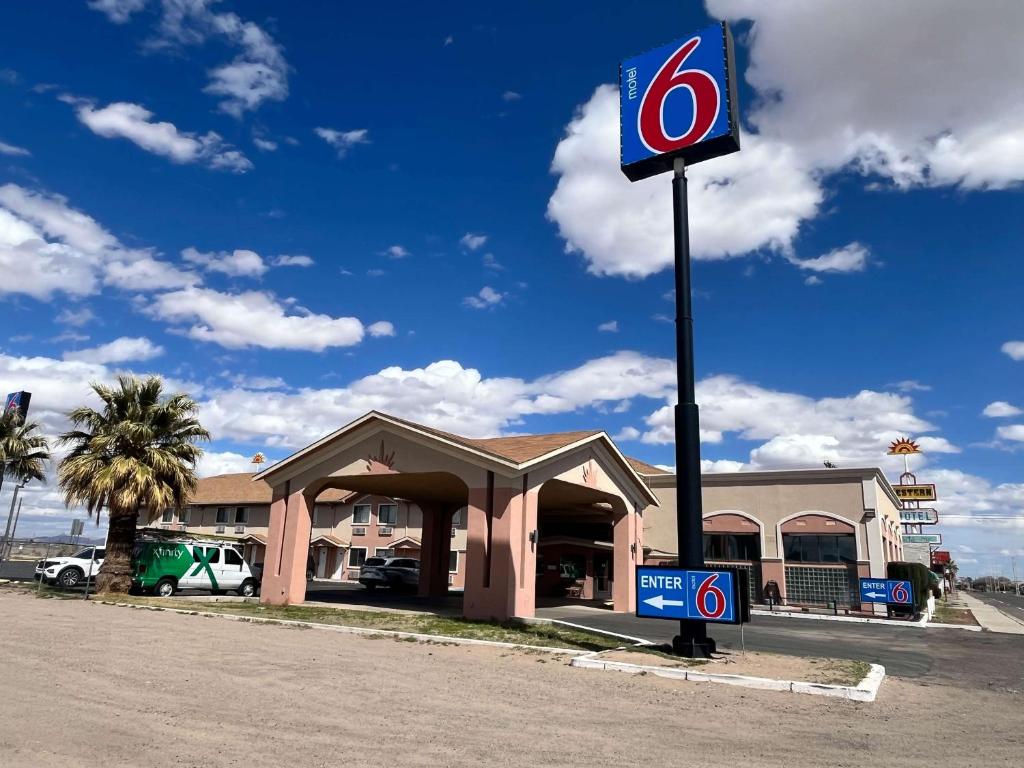 una señal en un poste frente a un concesionario en Motel 6 Deming, NM, en Deming