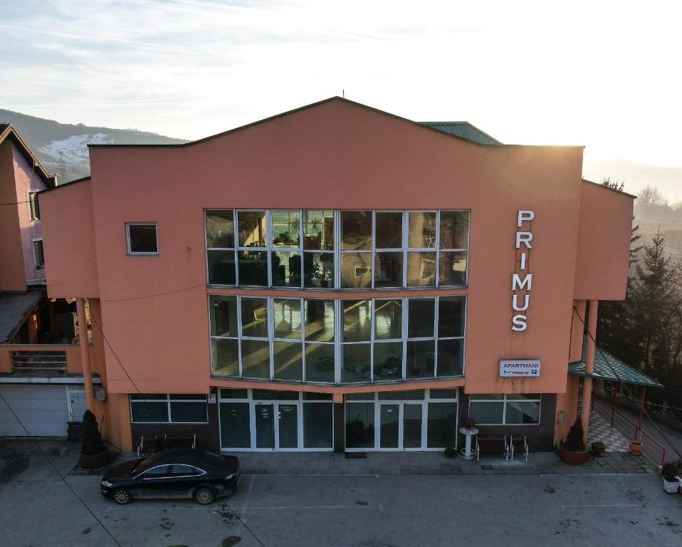 a building with a car parked in front of it at Primus Apartments in Visoko