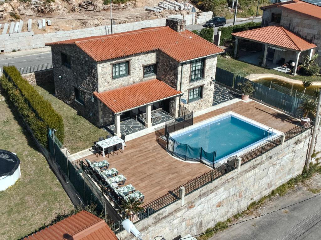 an aerial view of a house with a swimming pool at ThatsHome Villa Pedriñas in Sanxenxo
