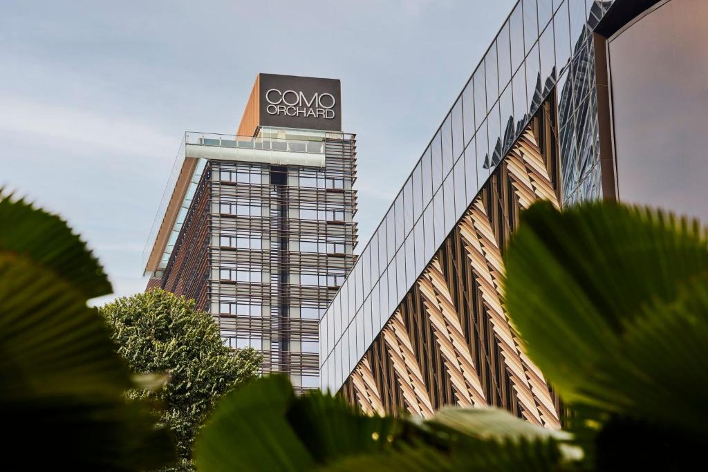 a building with a sign on the side of it at COMO Metropolitan Singapore in Singapore