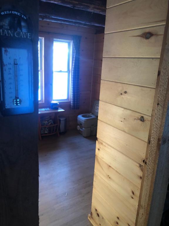 a room with a wooden wall and a window at Camp Rhino in Remsen