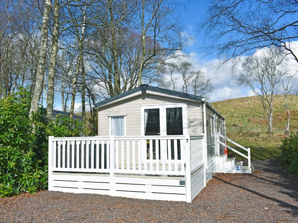 a small white house with a white fence at Saffron in Banchory