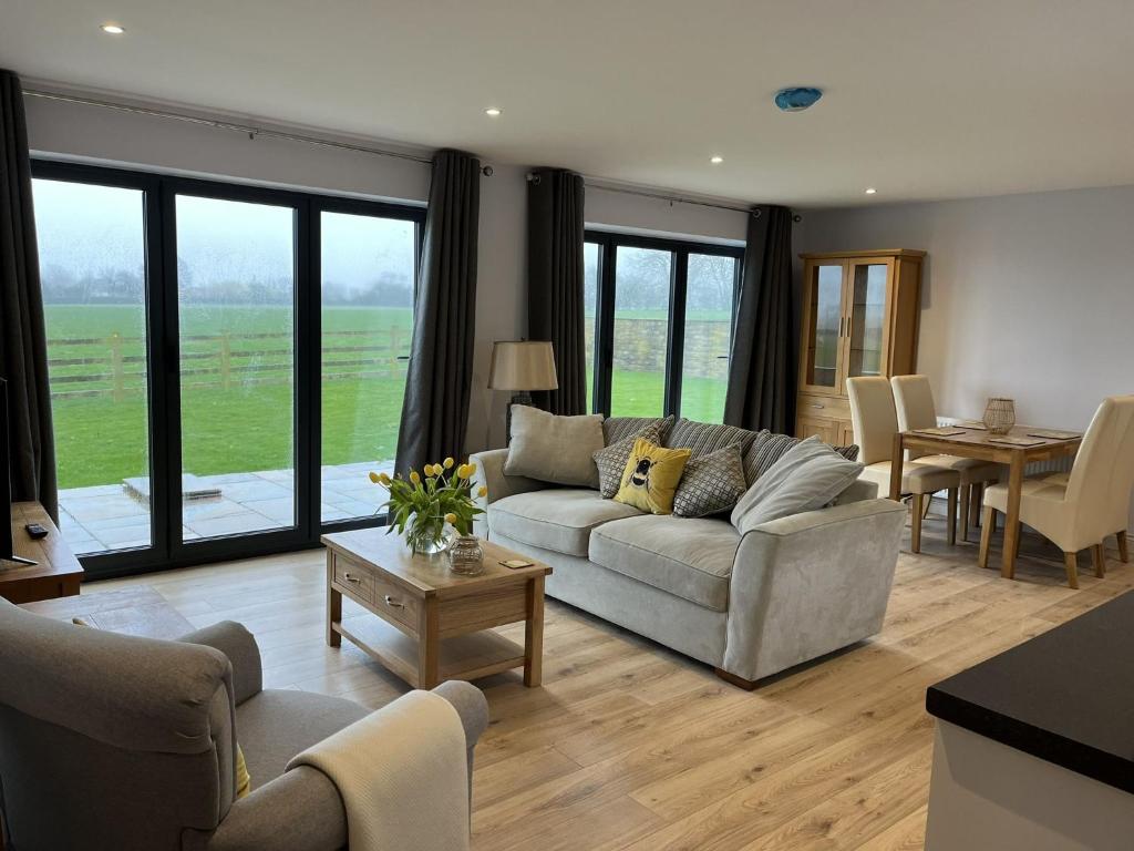 a living room with a couch and a table at Tunstall Farm Cottage in Tunstall