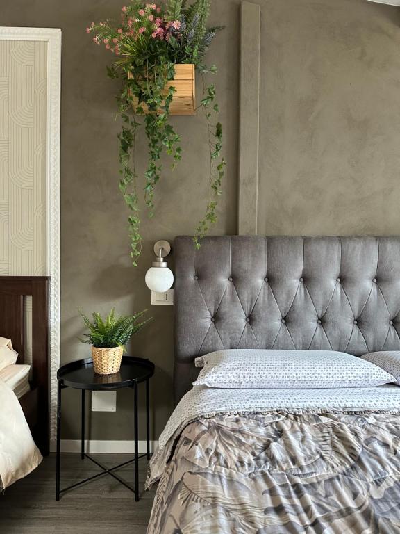a bedroom with a bed with plants on the wall at DEA DREAMS Marghera 43 in Milan