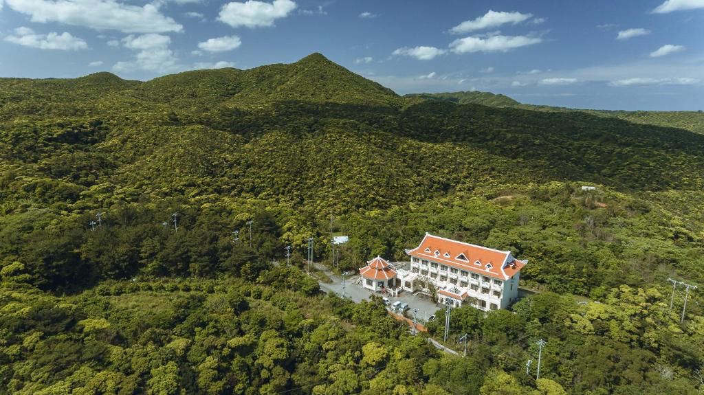 an aerial view of a building in the middle of a mountain at Ada Garden Hotel Okinawa in Kunigami
