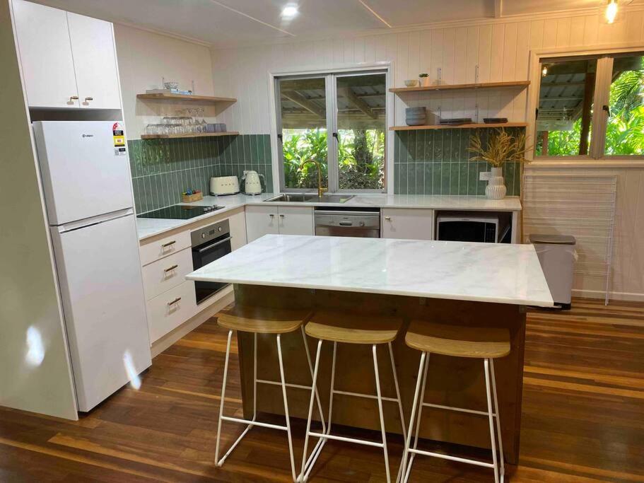 a kitchen with a white counter top and a refrigerator at The Treehouse at Alma Bay in Arcadia