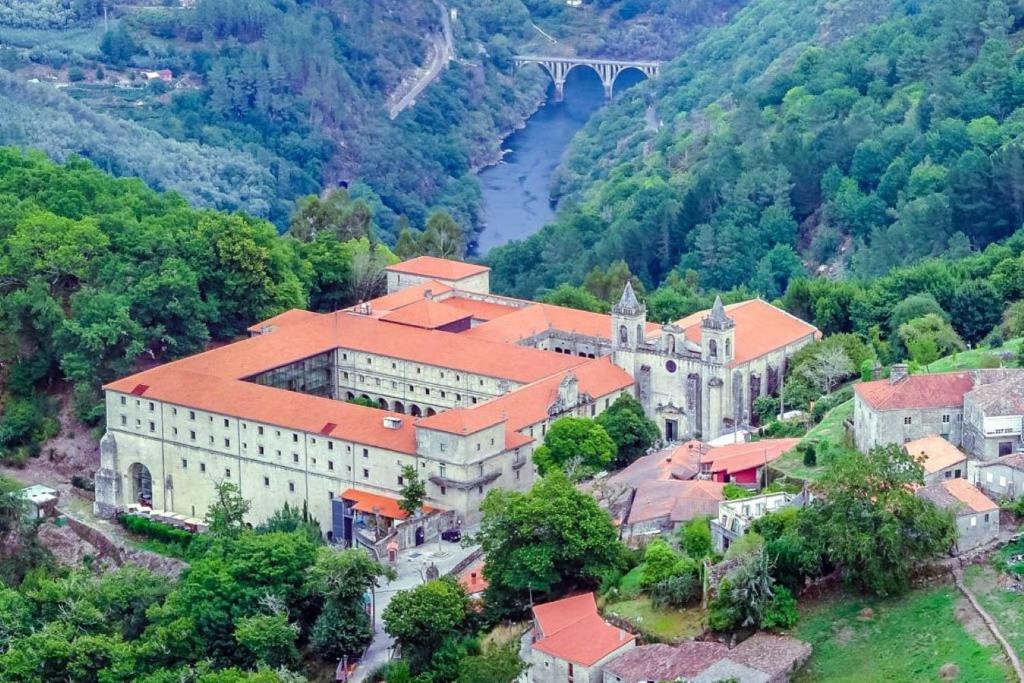 an aerial view of a building with a bridge in the background at La Casita in Nogueira de Ramuin