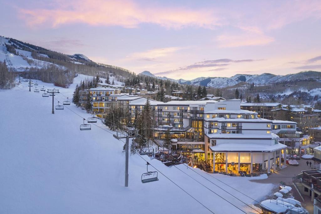 a ski resort in the snow with a ski lift at Viewline Resort Snowmass, Autograph Collection in Snowmass Village
