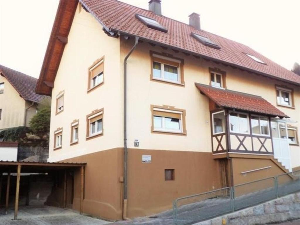 uma casa grande com garagem em frente em Ferienwohnung Kirchblick - b51898 em Langenbrand