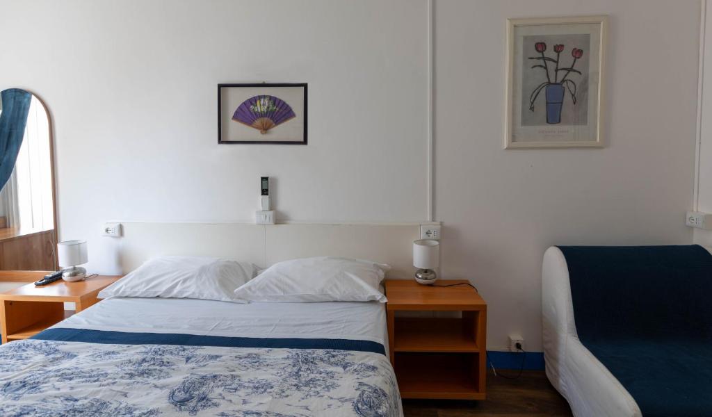 Postel nebo postele na pokoji v ubytování Olympia Hotel