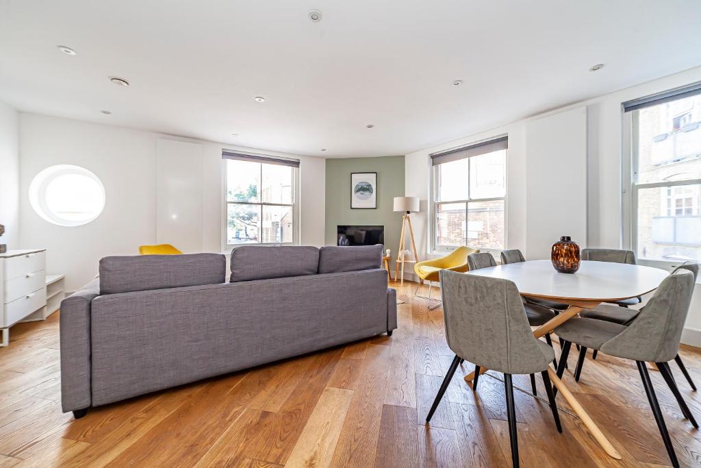 a living room with a couch and a table at The Old Street Luxury Flat in London