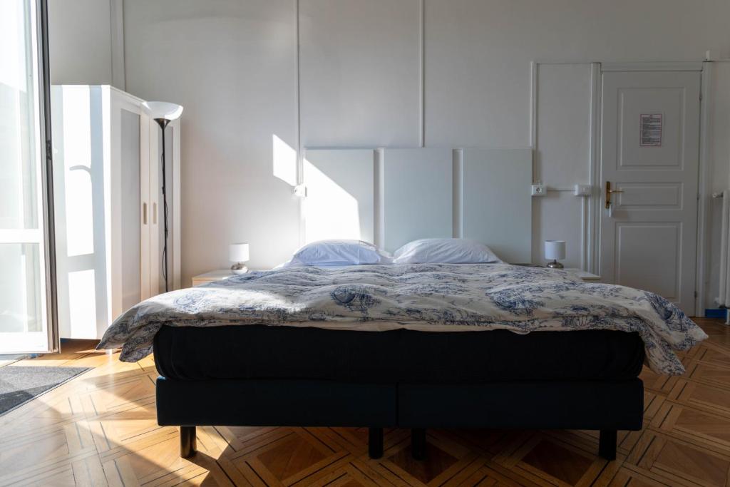 a bedroom with a bed with a blanket on it at Olympia Hotel in Genoa