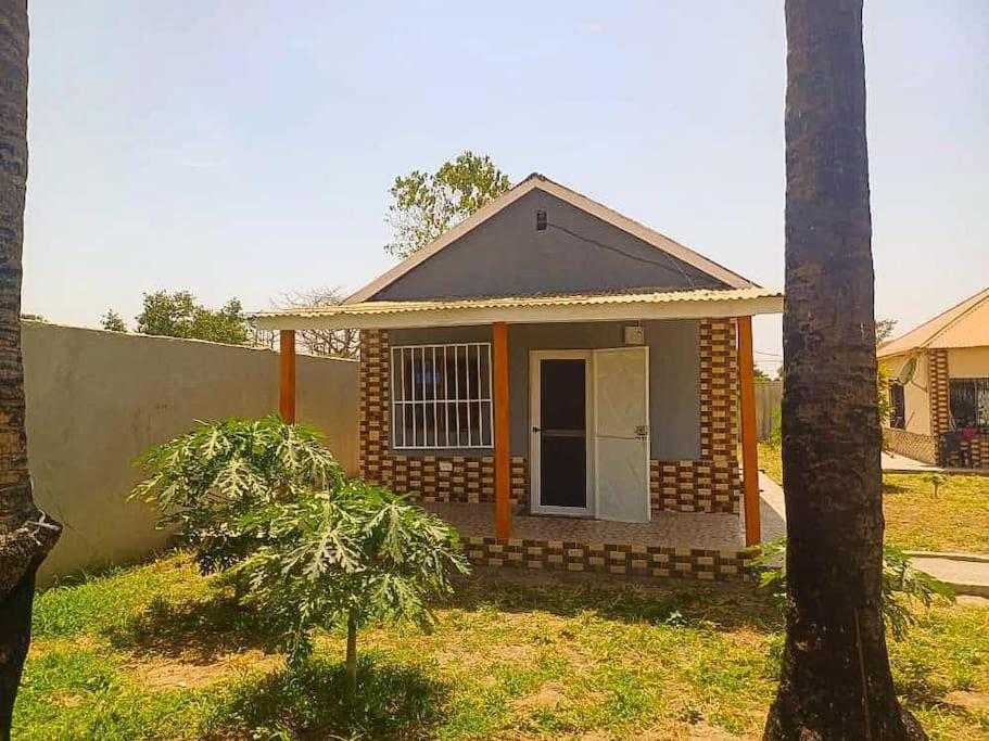 a small house with a tree in front of it at The Aladin House in Tujering