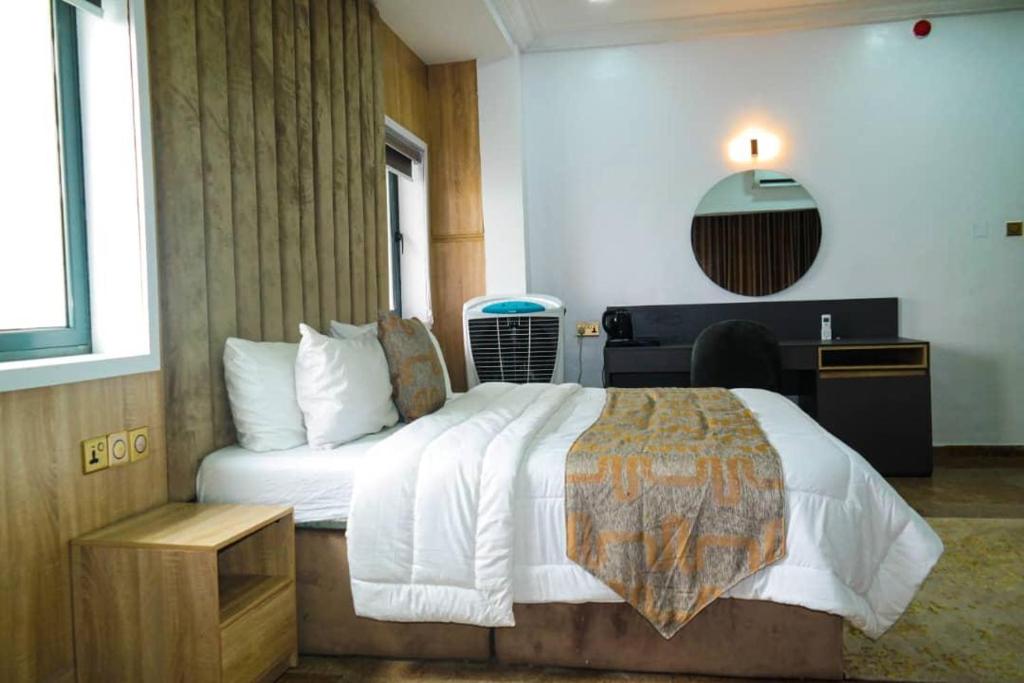 a hotel room with a bed and a desk at New View Beach Hotel and Resort Lekki Lagos in Lagos