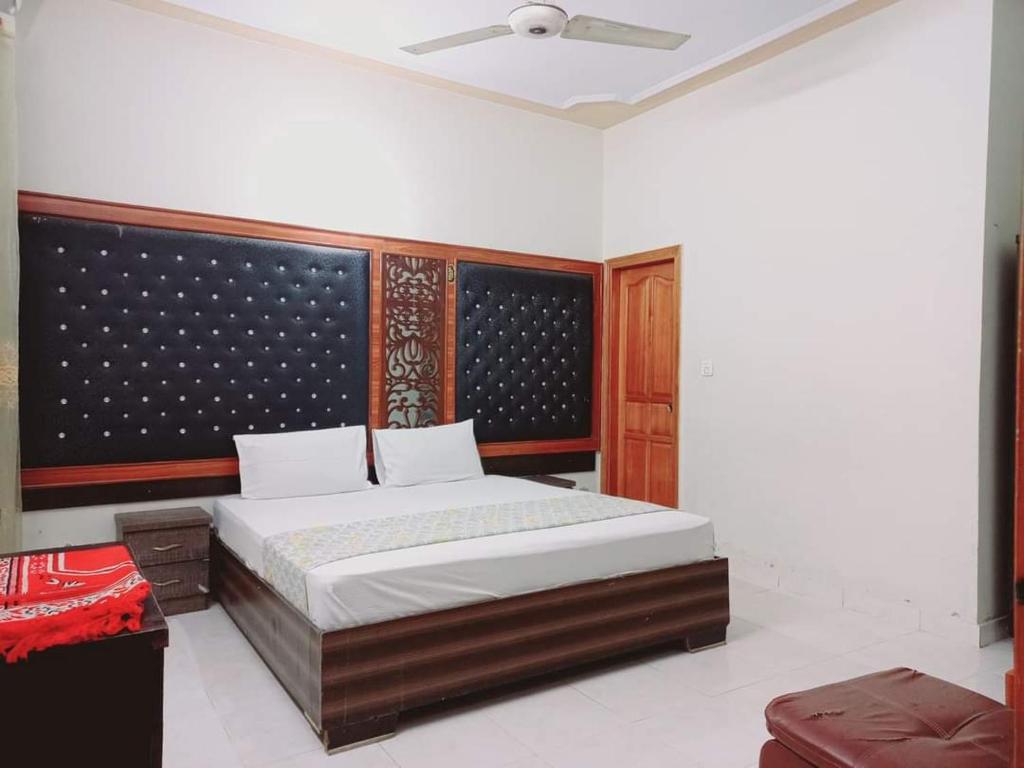 a bedroom with a large bed in a room at Rose Palace Millennium in Karachi
