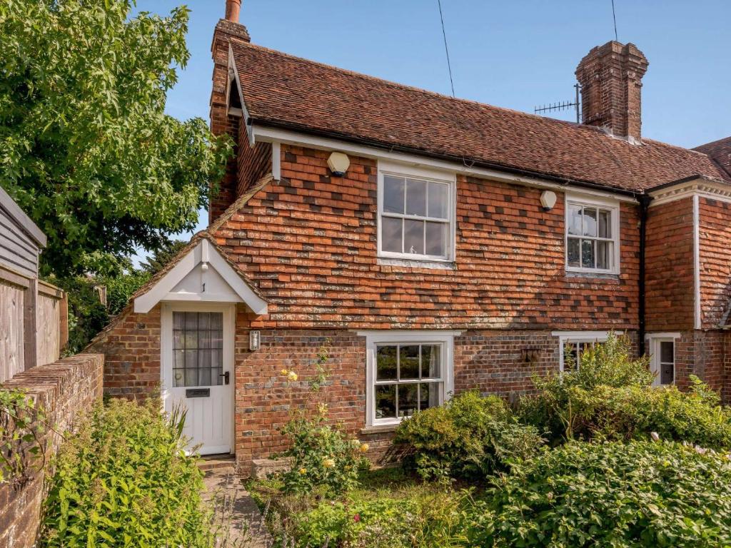 an old brick house with a white door at 1 bed in Sedlescombe 83845 in Sedlescombe