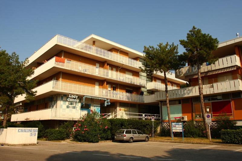 a car parked in front of a large building at CAVALLINO in Bibione