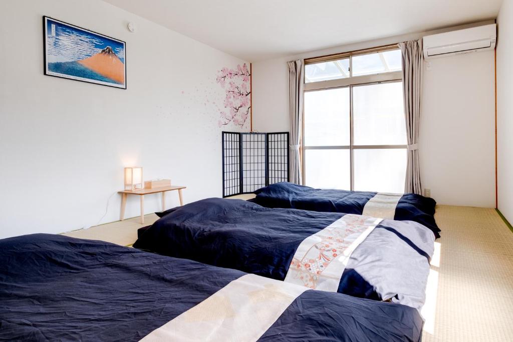 松本市にあるForest Agataのベッド2台 窓付きのベッドルーム1室