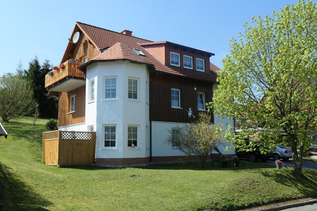 a large house with a brown and white at Ferienwohnung Turmeck in Altenau