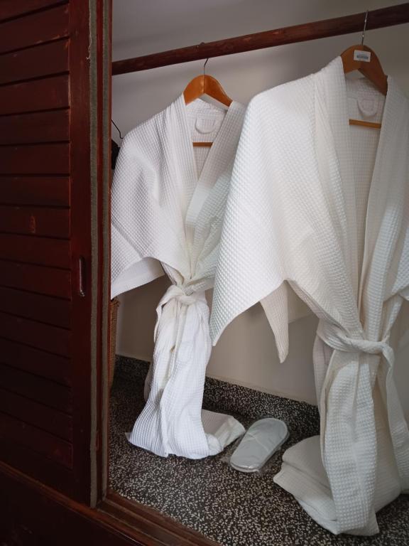 a closet filled with white clothes and shoes at Andy's Place in Siem Reap