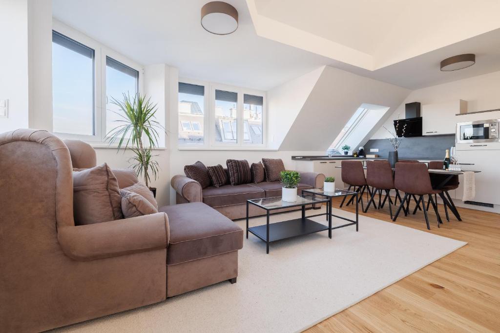 ein Wohnzimmer mit einem Sofa und einem Tisch in der Unterkunft SYMPHONY Apartments 40 - Modern Loft with Terrace and Grill in Central Location in Wien