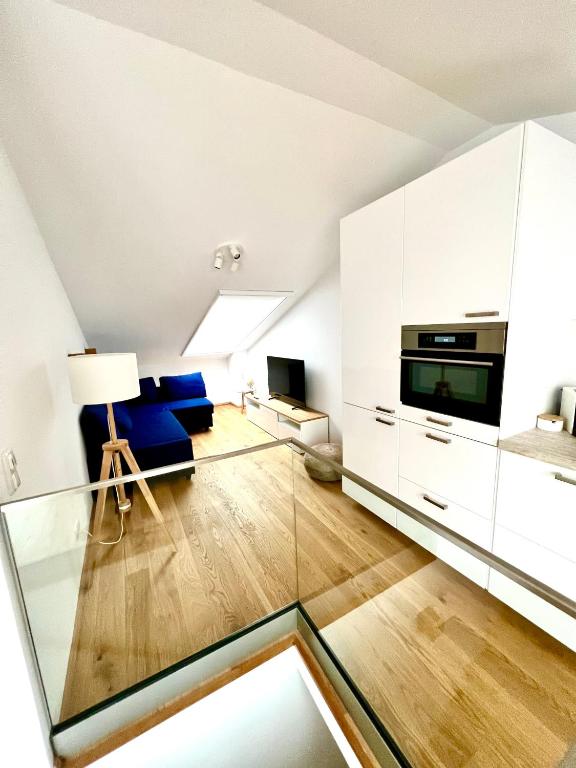 a living room with a glass table in a room at Gmunden Skyline in Gmunden