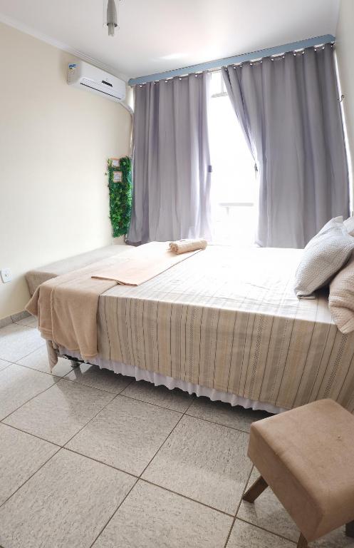 a bedroom with a large bed with a window at Apto com vista para Baía do Guajará in Belém