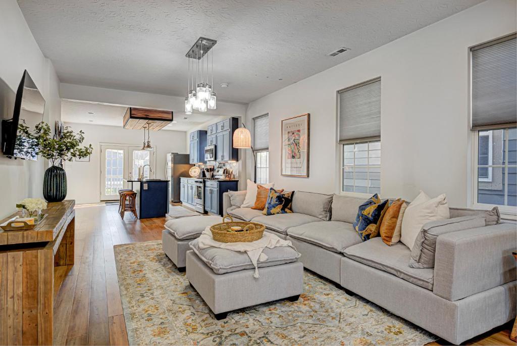 a living room with a couch and a table at Spacious Bates-Hendricks Home ~ 5 Min to Lucas Oil in Indianapolis