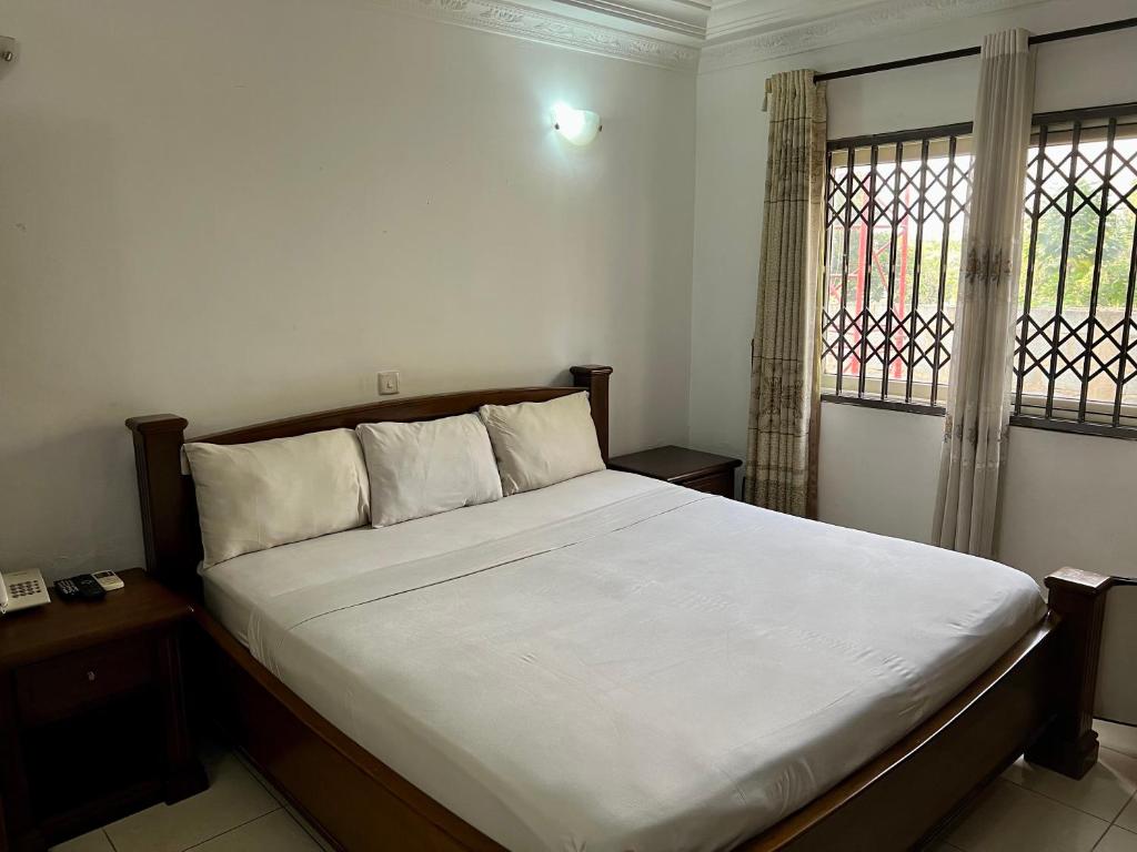 Tempat tidur dalam kamar di Empress Guest House