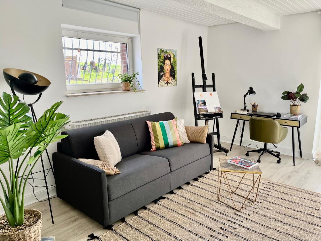 a living room with a couch and a table at Art-Apartment with Terrace in Monschau in Monschau